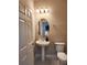 Bathroom featuring a pedestal sink, oval mirror, and neutral tones at 813 Marsh Reed Dr, Winter Garden, FL 34787