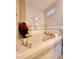 Close up of a soaking tub, decorated with flowers and candles, in a bright bathroom at 813 Marsh Reed Dr, Winter Garden, FL 34787