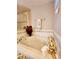 Close up of a soaking tub, decorated with candles and towels, in a bright bathroom at 813 Marsh Reed Dr, Winter Garden, FL 34787