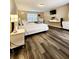 Bright bedroom with wood-look flooring, large window and a bright white bed frame at 813 Marsh Reed Dr, Winter Garden, FL 34787