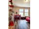 Bedroom featuring wood-look flooring, large windows, and vibrant decor at 813 Marsh Reed Dr, Winter Garden, FL 34787