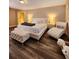 Well-lit bedroom featuring hardwood floors and a bright white bed frame at 813 Marsh Reed Dr, Winter Garden, FL 34787