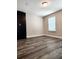 Spacious bedroom with wood laminate flooring, closet, and neutral-colored walls at 813 Marsh Reed Dr, Winter Garden, FL 34787