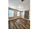 Bedroom with wood laminate flooring, neutral walls, and two windows with natural light at 813 Marsh Reed Dr, Winter Garden, FL 34787