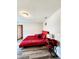 Bedroom featuring a red bed set, wood-look floors, and neutral wall color at 813 Marsh Reed Dr, Winter Garden, FL 34787