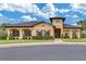Exterior of the clubhouse with manicured landscaping and ample parking at 813 Marsh Reed Dr, Winter Garden, FL 34787