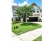 Well-maintained front yard of a two-story home with lush green grass and mature trees, and brick driveway at 813 Marsh Reed Dr, Winter Garden, FL 34787