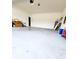Large, empty three-car garage offering ample space for vehicles and storage at 813 Marsh Reed Dr, Winter Garden, FL 34787