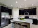 Modern kitchen with stainless steel appliances, granite countertops and a convenient island at 813 Marsh Reed Dr, Winter Garden, FL 34787