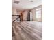 Open living room featuring wood laminate flooring, natural light, and stainless refrigerator at 813 Marsh Reed Dr, Winter Garden, FL 34787