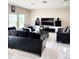 Comfortable living room featuring tile flooring, black furniture and natural light at 813 Marsh Reed Dr, Winter Garden, FL 34787