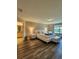 A primary bedroom with wood floors, luxury bed and furniture, and a view to the exterior at 813 Marsh Reed Dr, Winter Garden, FL 34787