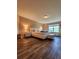 A primary bedroom with wood floors, luxury bed and furniture, and a view to the exterior at 813 Marsh Reed Dr, Winter Garden, FL 34787