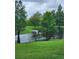 Scenic pond surrounded by lush green grass and mature trees, creating a peaceful backyard at 813 Marsh Reed Dr, Winter Garden, FL 34787
