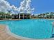 Community pool view with lounge chairs and clubhouse on a sunny day at 813 Marsh Reed Dr, Winter Garden, FL 34787