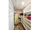 Organized walk-in closet featuring wire shelving and a wooden floor at 813 Marsh Reed Dr, Winter Garden, FL 34787