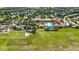Aerial view of a community center featuring a pool, tennis courts, green spaces, and parking at 911 Tidal Pond Dr, Groveland, FL 34736