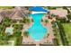 Aerial view of community pool area with blue pool, shade, sun loungers and landscaping at 911 Tidal Pond Dr, Groveland, FL 34736