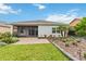 This backyard features a lush lawn, patio, and well-maintained landscaping with low lighting at 911 Tidal Pond Dr, Groveland, FL 34736