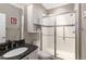 This bathroom features an enclosed glass shower, granite vanity and built in medicine cabinet at 911 Tidal Pond Dr, Groveland, FL 34736