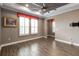 Spacious bedroom with trey ceilings, crown molding, neutral paint, and shuttered windows at 911 Tidal Pond Dr, Groveland, FL 34736