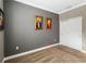 This bedroom has neutral carpeting, paint, and trim and includes 2 framed pieces of artwork at 911 Tidal Pond Dr, Groveland, FL 34736