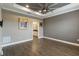 Spacious bedroom with trey ceilings, crown molding, neutral paint, and access to the bathroom at 911 Tidal Pond Dr, Groveland, FL 34736
