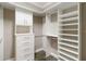 Walk-in closet with custom shelving and built-in drawers for ample storage at 911 Tidal Pond Dr, Groveland, FL 34736