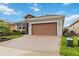 Spacious paved driveway leading to the garage of a well-maintained single-story home at 911 Tidal Pond Dr, Groveland, FL 34736