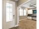 Inviting entryway featuring a decorative glass door and a view into a home office at 911 Tidal Pond Dr, Groveland, FL 34736