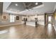 Spacious open living area featuring modern lighting, tile backsplash and wood-look floors at 911 Tidal Pond Dr, Groveland, FL 34736