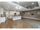 Bright living space with a modern kitchen, tile backsplash and a gray accent wall at 911 Tidal Pond Dr, Groveland, FL 34736
