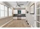 Bright home office featuring custom built-in cabinets, a desk area, and natural light at 911 Tidal Pond Dr, Groveland, FL 34736