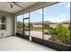 This screened in patio overlooks a well manicured lawn and brick paved walkway at 911 Tidal Pond Dr, Groveland, FL 34736