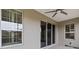 This patio features multiple windows and a sliding glass door, providing ample light and views at 911 Tidal Pond Dr, Groveland, FL 34736