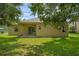 View of the home's backyard with lush green grass and mature trees at 9650 Bay Pine Ln, Orlando, FL 32832