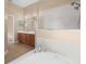 Bright bathroom featuring a soaking tub and tiled floors at 9650 Bay Pine Ln, Orlando, FL 32832