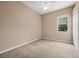 Neutral bedroom featuring a ceiling fan, window, and double door closet at 9650 Bay Pine Ln, Orlando, FL 32832