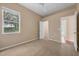 Neutral bedroom featuring a window and door at 9650 Bay Pine Ln, Orlando, FL 32832