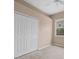 Neutral bedroom featuring a window and double door closet at 9650 Bay Pine Ln, Orlando, FL 32832