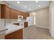 Cozy kitchen featuring tiled flooring, wooden cabinets, and modern white appliances at 9650 Bay Pine Ln, Orlando, FL 32832