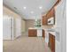 Bright kitchen with tile floors, light wood cabinets, and white appliances, open to living areas at 9650 Bay Pine Ln, Orlando, FL 32832