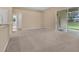 Spacious living room with neutral carpet and natural light from sliding glass doors at 9650 Bay Pine Ln, Orlando, FL 32832