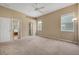 Spacious main bedroom featuring neutral carpet, multiple windows, and walk-in closet at 9650 Bay Pine Ln, Orlando, FL 32832