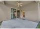 Covered patio features a ceiling fan and sliding glass doors to the interior at 9650 Bay Pine Ln, Orlando, FL 32832