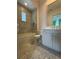 Well-lit bathroom with a combination tub/shower, patterned accent wall, and stylish vanity at 10143 Mattraw Pl, Golden Oak, FL 32836