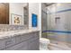 Contemporary bathroom with glass shower, granite countertop, and gray vanity for a sleek look at 10143 Mattraw Pl, Golden Oak, FL 32836