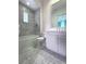 Well-lit bathroom featuring a tub, patterned wallpaper, stylish vanity and tiled floors at 10143 Mattraw Pl, Golden Oak, FL 32836