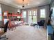 Spacious bedroom with modern bunk beds, study area and ample natural light at 10143 Mattraw Pl, Golden Oak, FL 32836