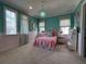 Whimsical bedroom featuring colorful accents, two windows, and a cozy atmosphere at 10143 Mattraw Pl, Golden Oak, FL 32836
